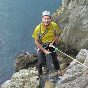 Picture of Membership Secretary Jules abseiling into 'Dream of White Horses' at Gogarth